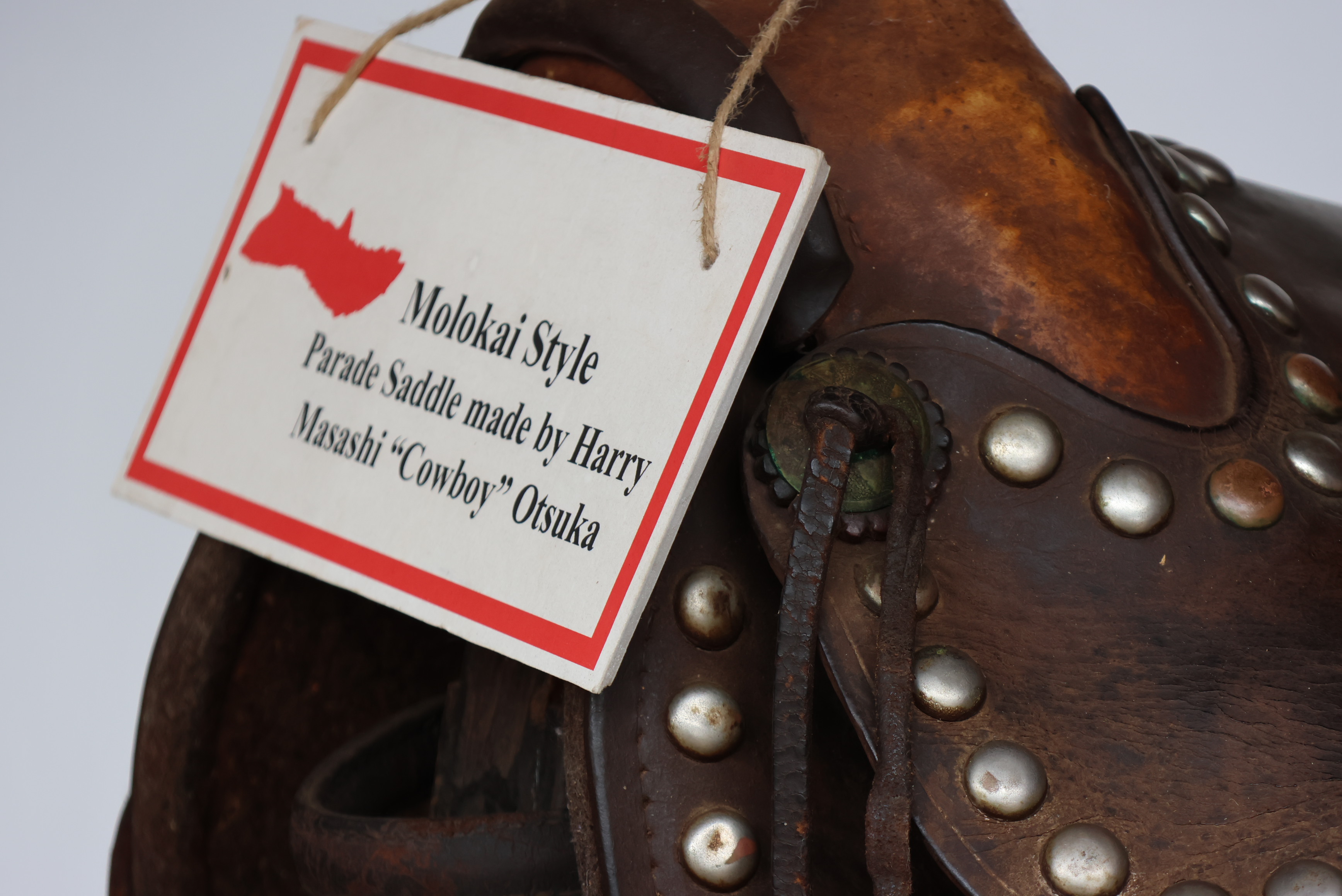 Leather paniolo saddle with hand-tooled details, used for ranch work in Hawaiʻi.